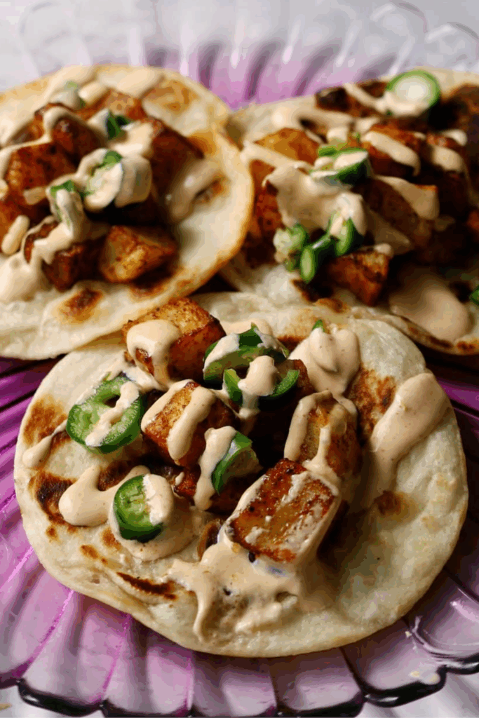 spicy potato tacos on a plate