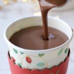 the polar express hot chocolate recipe being poured into a cup.