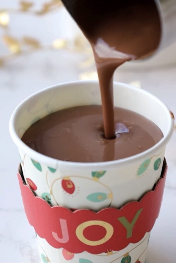 the polar express hot chocolate recipe being poured into a cup.