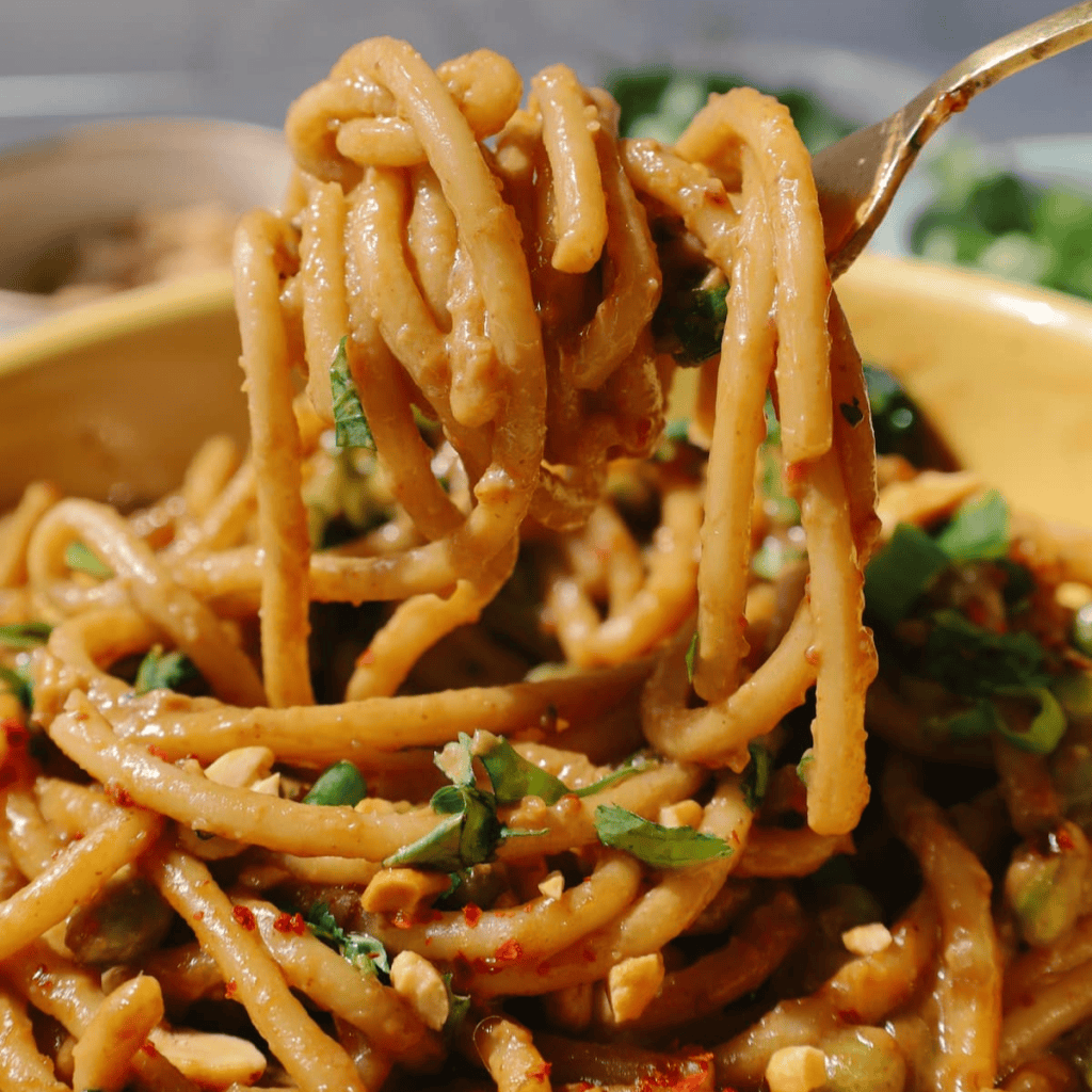 Spicy peanut noodles twirled around a fork.