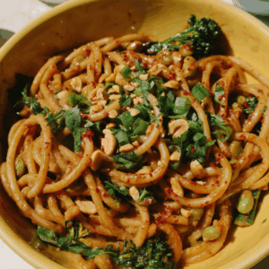 spicy peanut noodles with scallions and cilantro on top