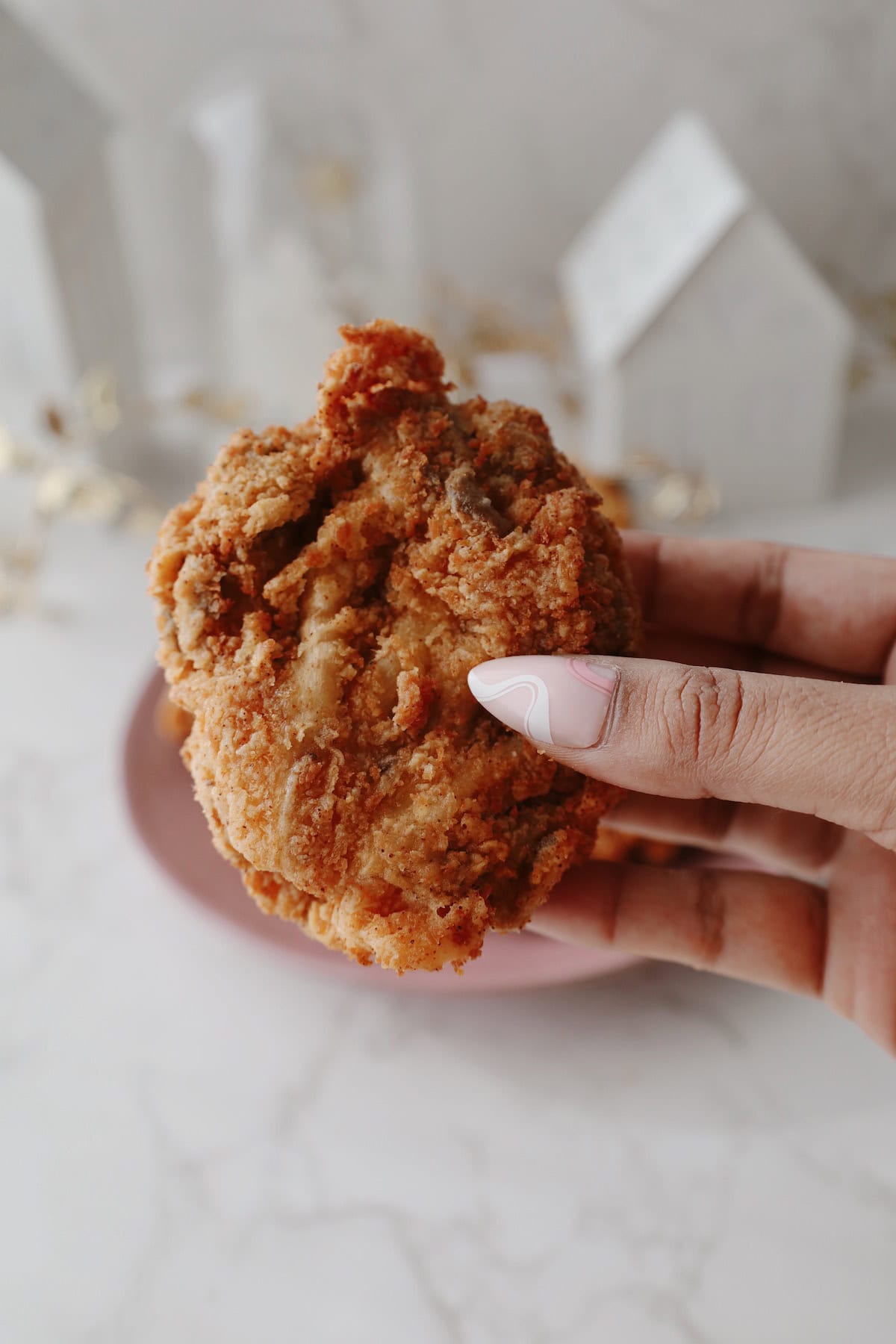 Oyster mushroom fried chicken tender held in someone's hand.