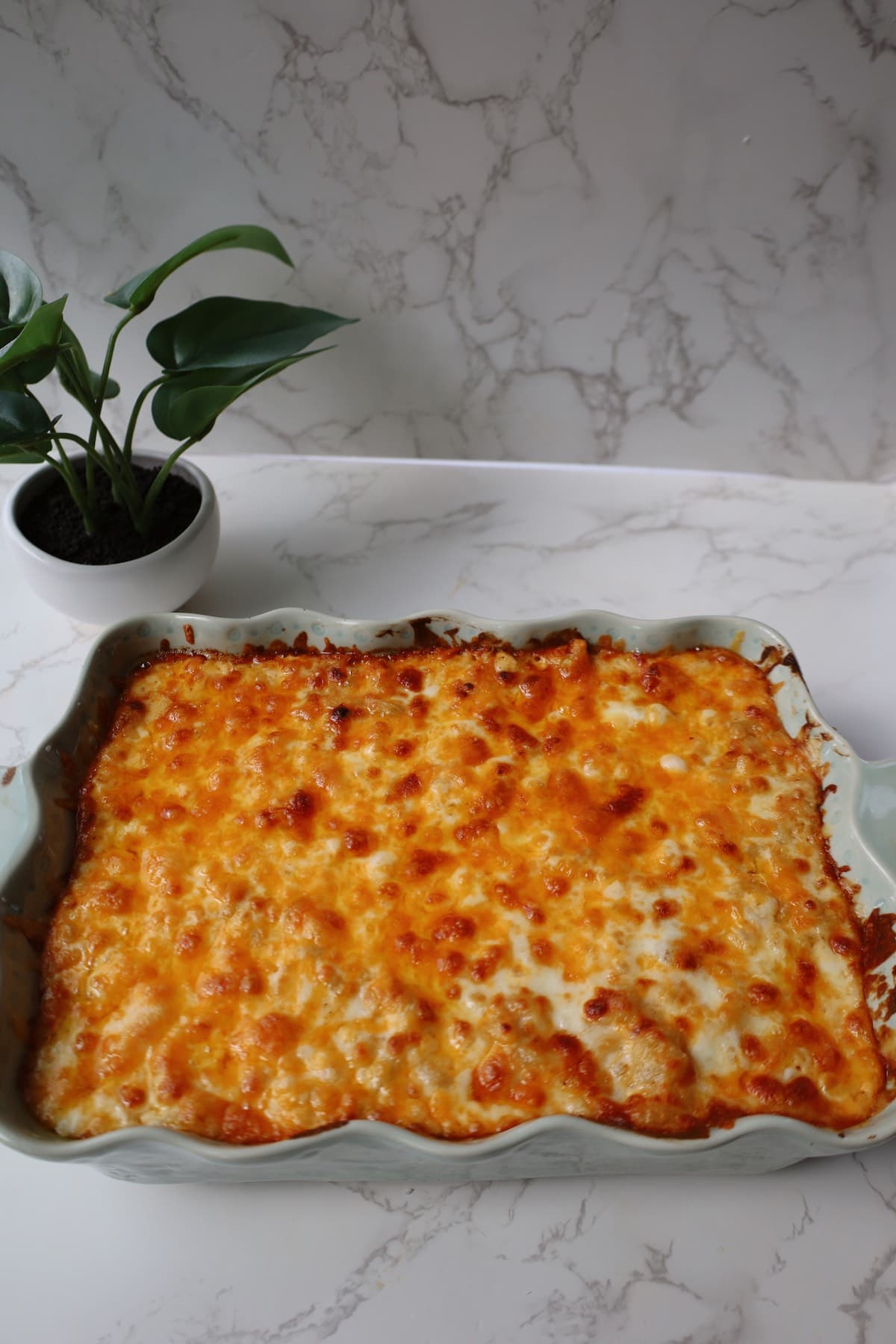 Extra cheesy mac and cheese inside of a large baking dish.