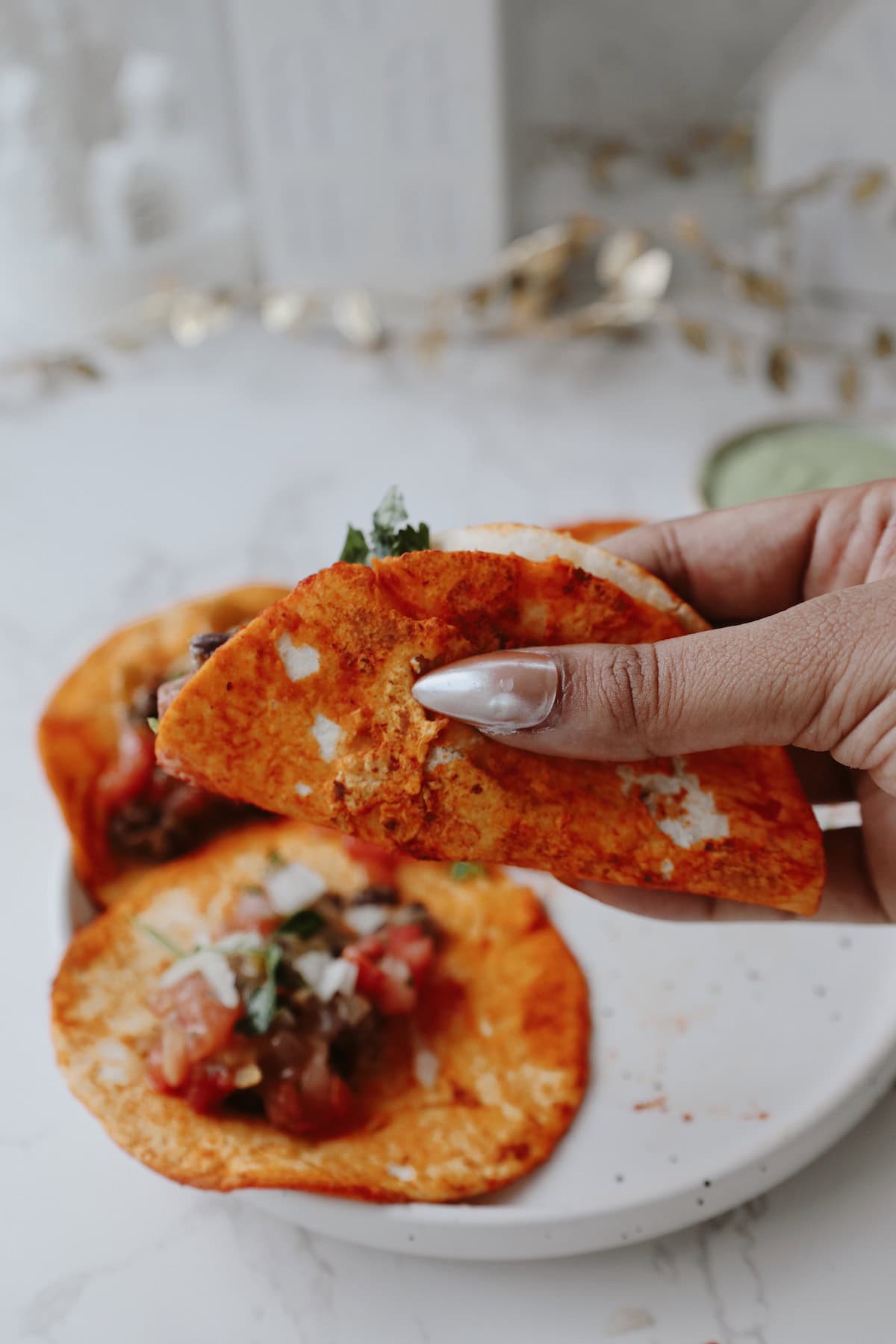 black bean tacos being held by a hand