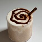 Cinnamon roll overnight oats in a cup.