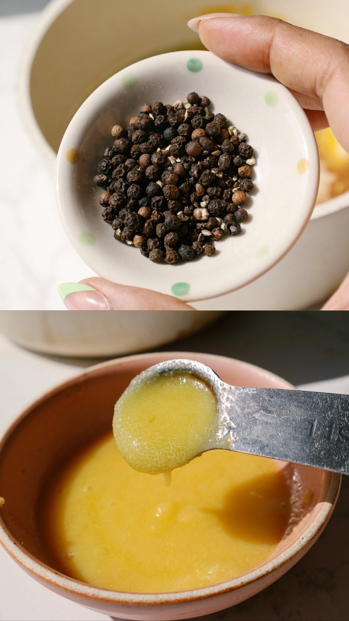 A close up of whole peppercorns and a spoon of ghee.