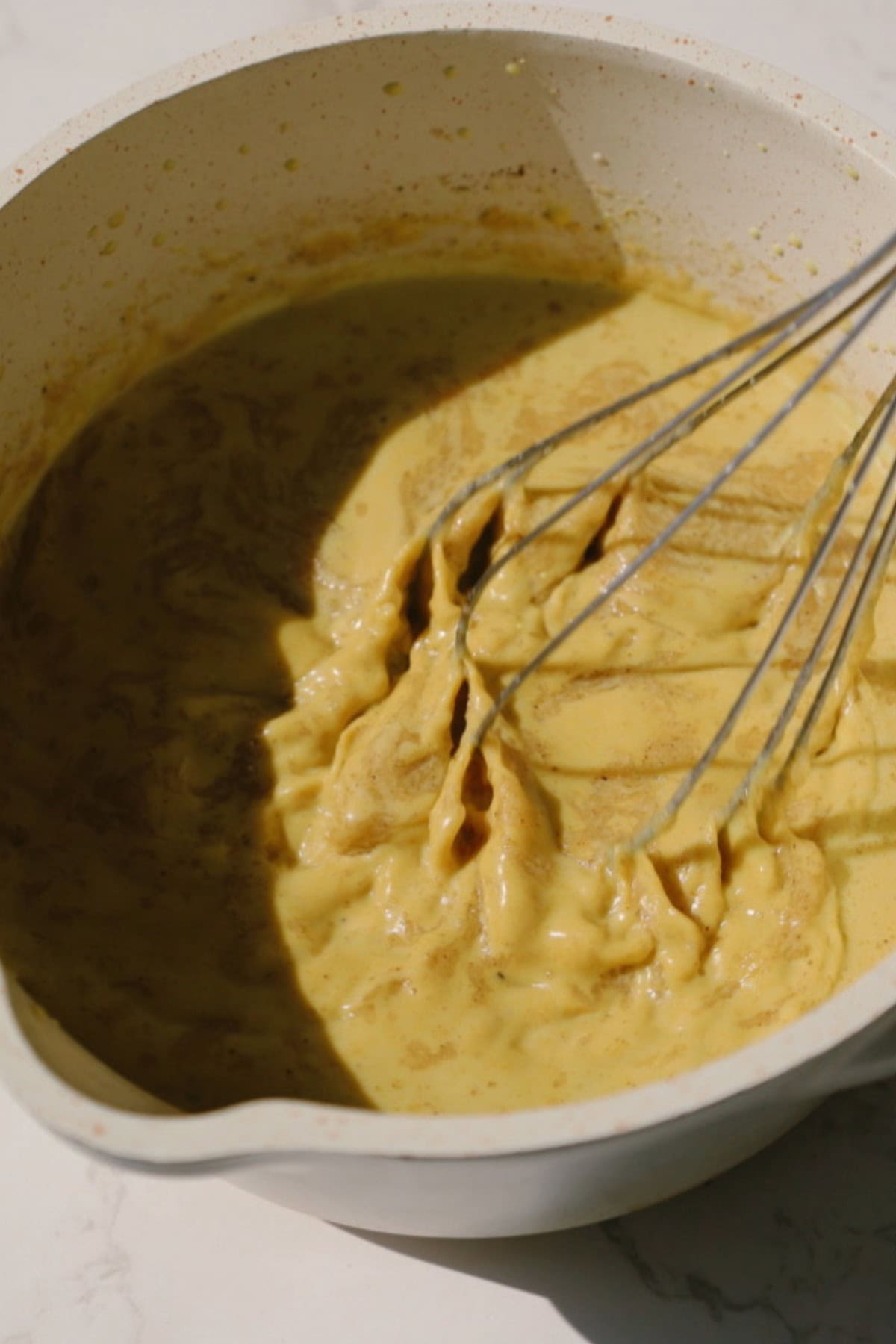 Step three: add the ghee and whisk.