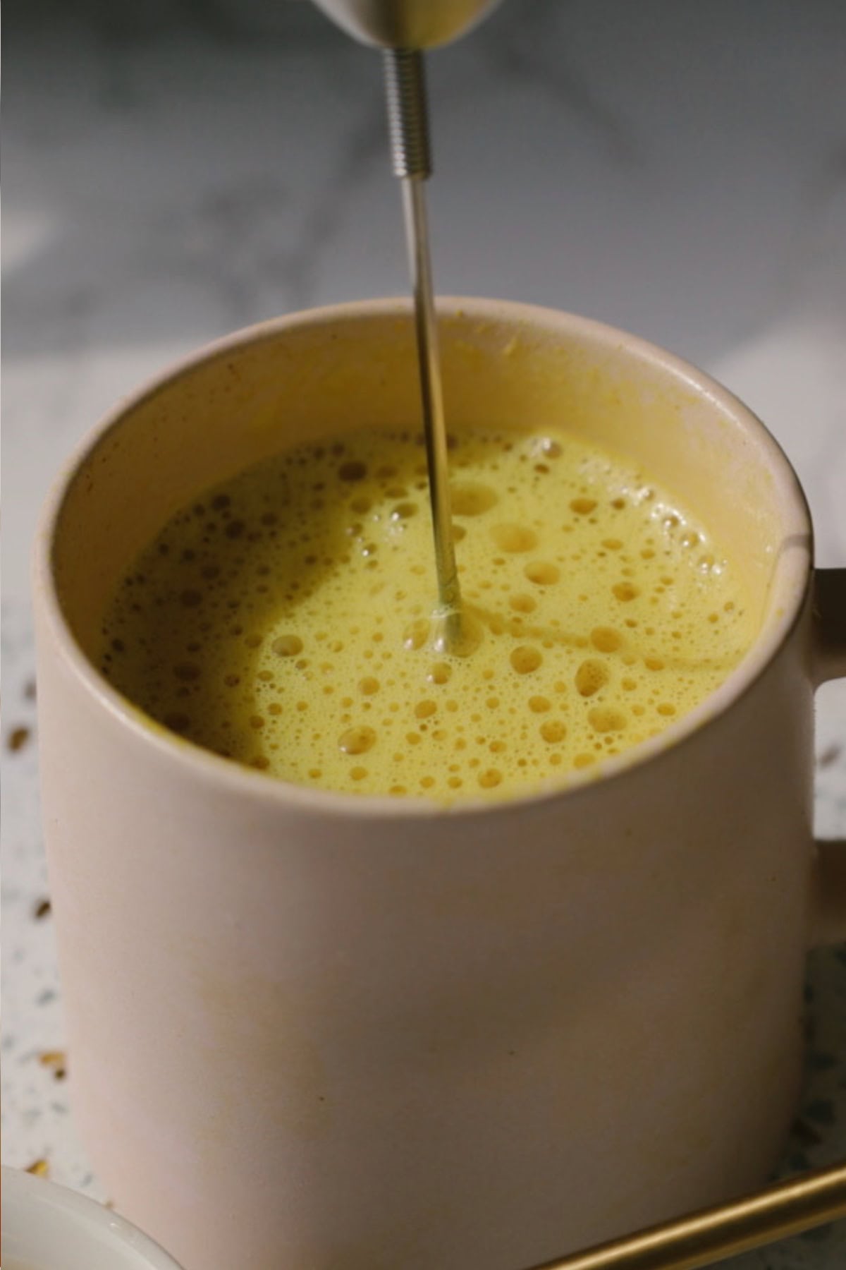 Step six: froth the golden milk.