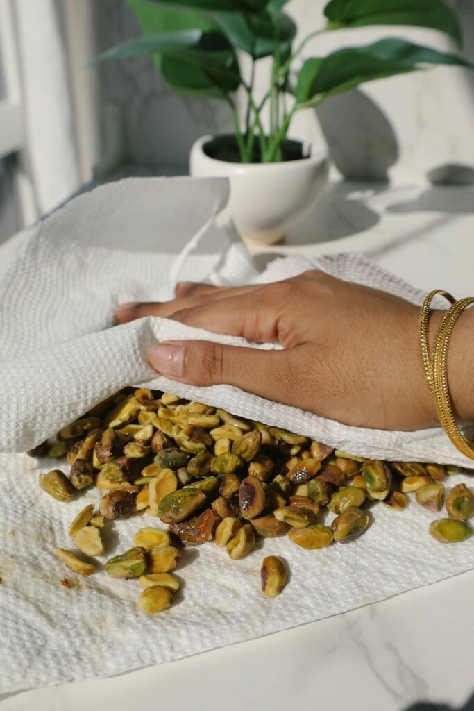 how to take the outer layer off the pistachios with a paper towel 