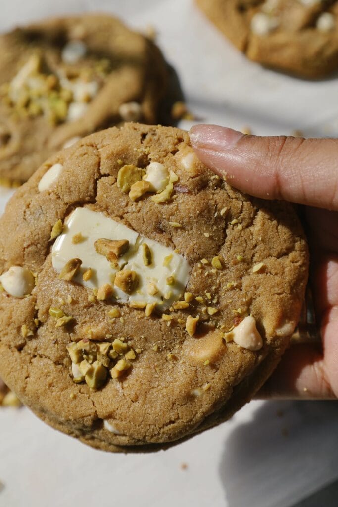 pistachio cookie being held by a hand