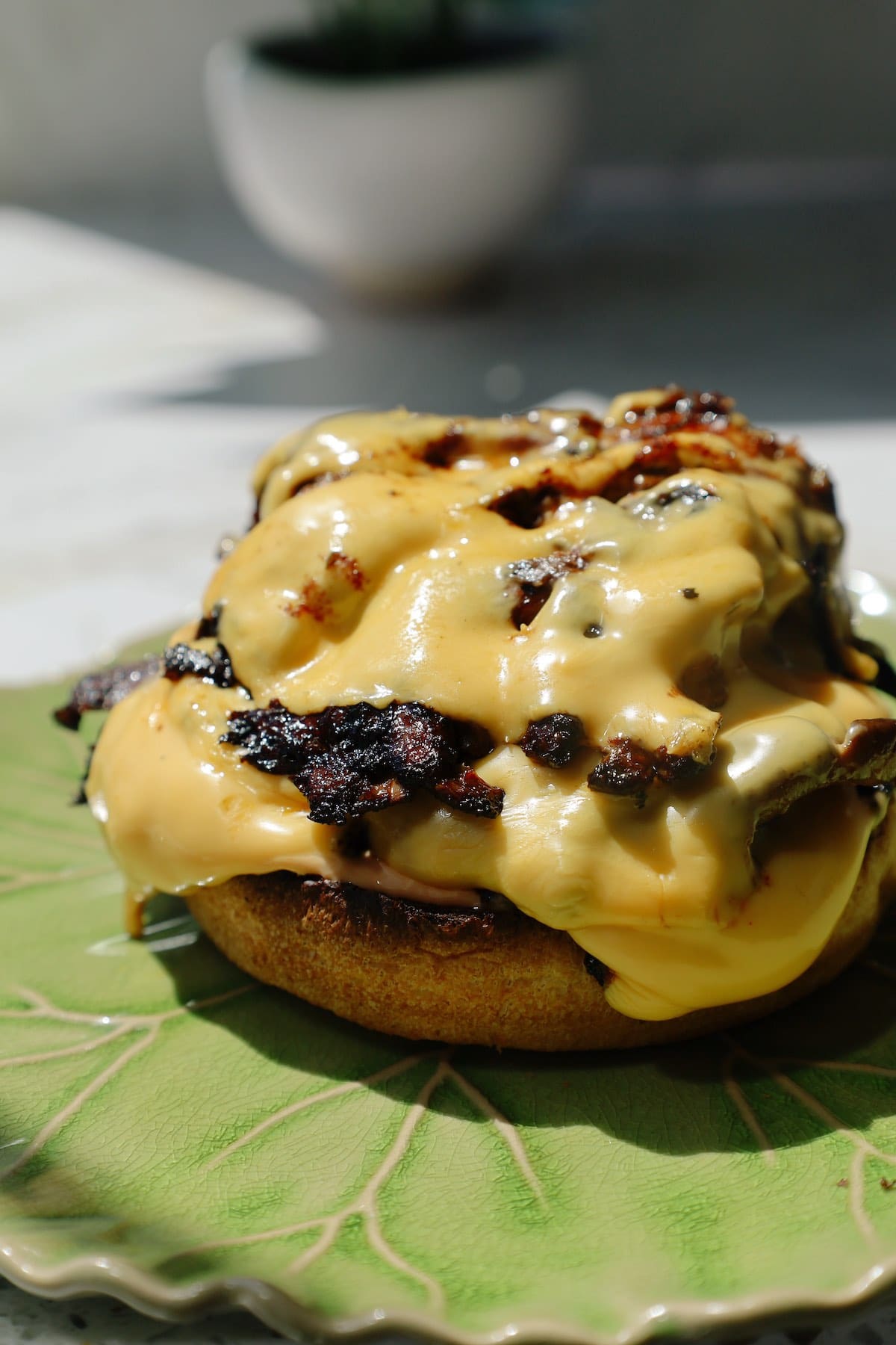 Vegetarian smash burger with crispy oyster mushrooms, melted cheese, and pickled jalapeños in a brioche bun.