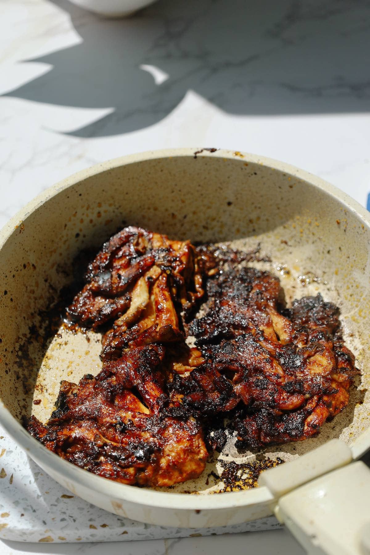 Oyster mushrooms searing in a hot skillet until browned and crispy around the edges.