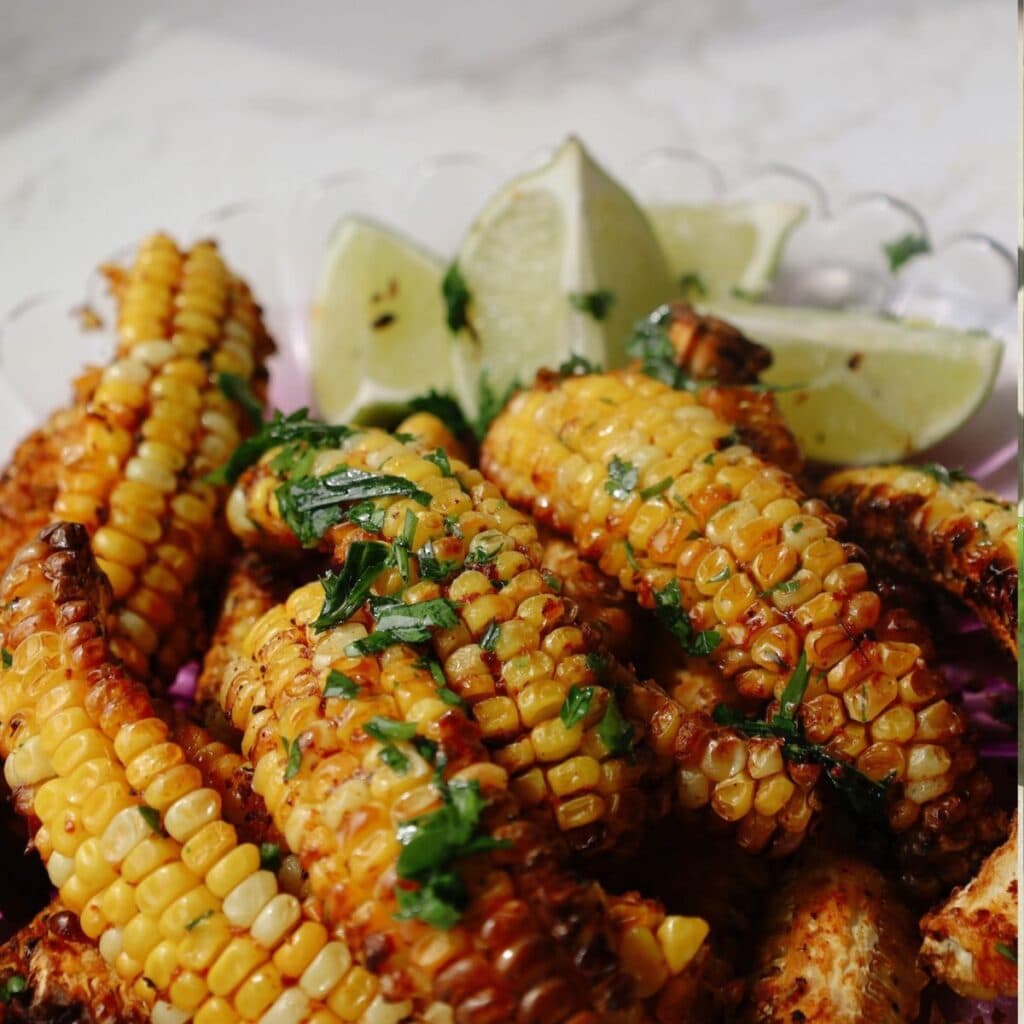 Corn ribs recipe on a plate with limes.
