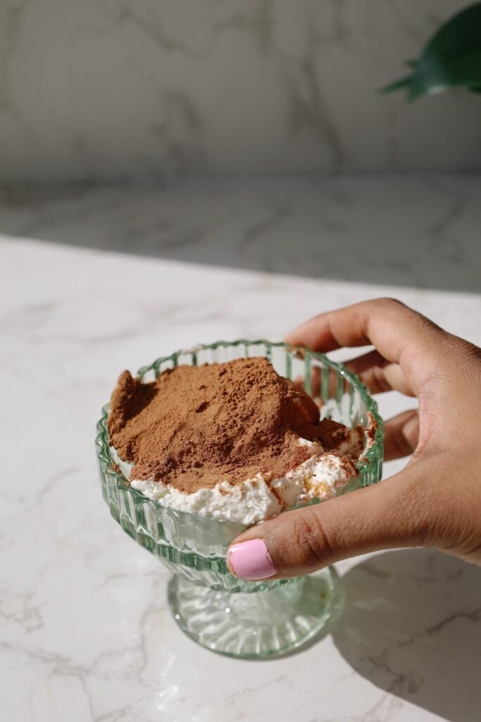 hand holding dessert glass