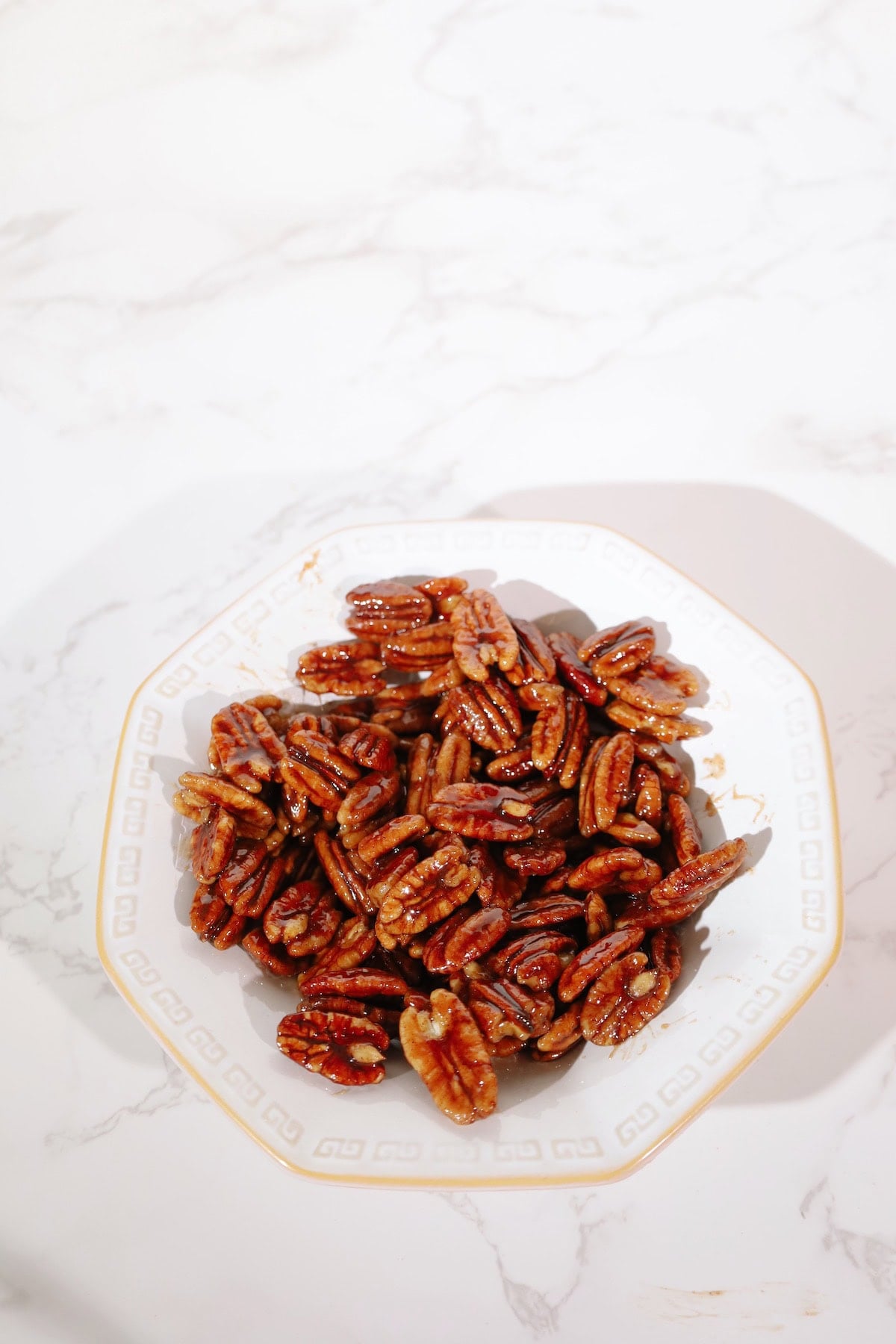 Candied pecans recipe on a plate.
