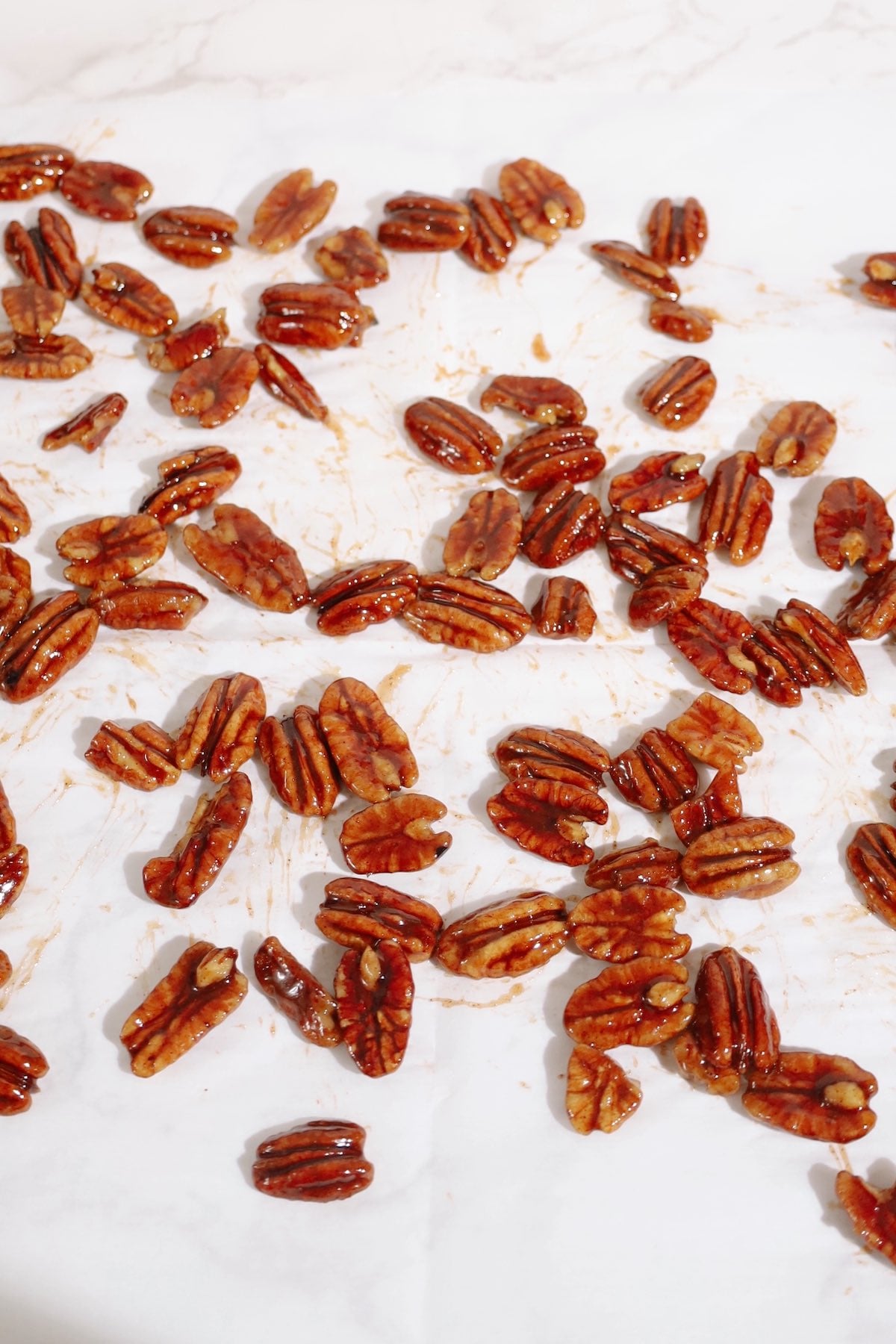 Step four: spread the candied pecans on parchment paper.