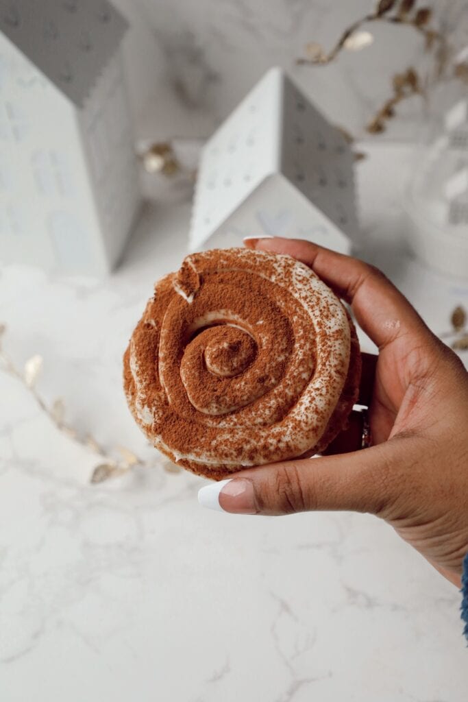 Tiramisu cookie with frosting and cocoa powder.