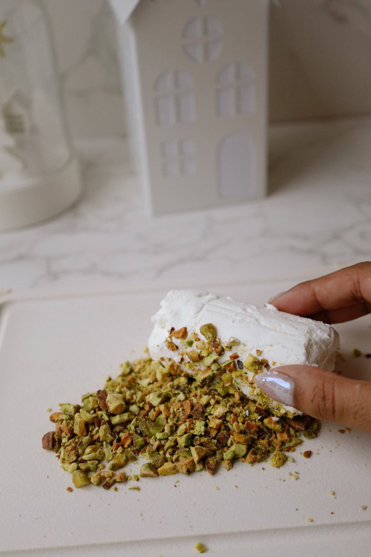 Step two: roll the goat cheese in the pistachios.