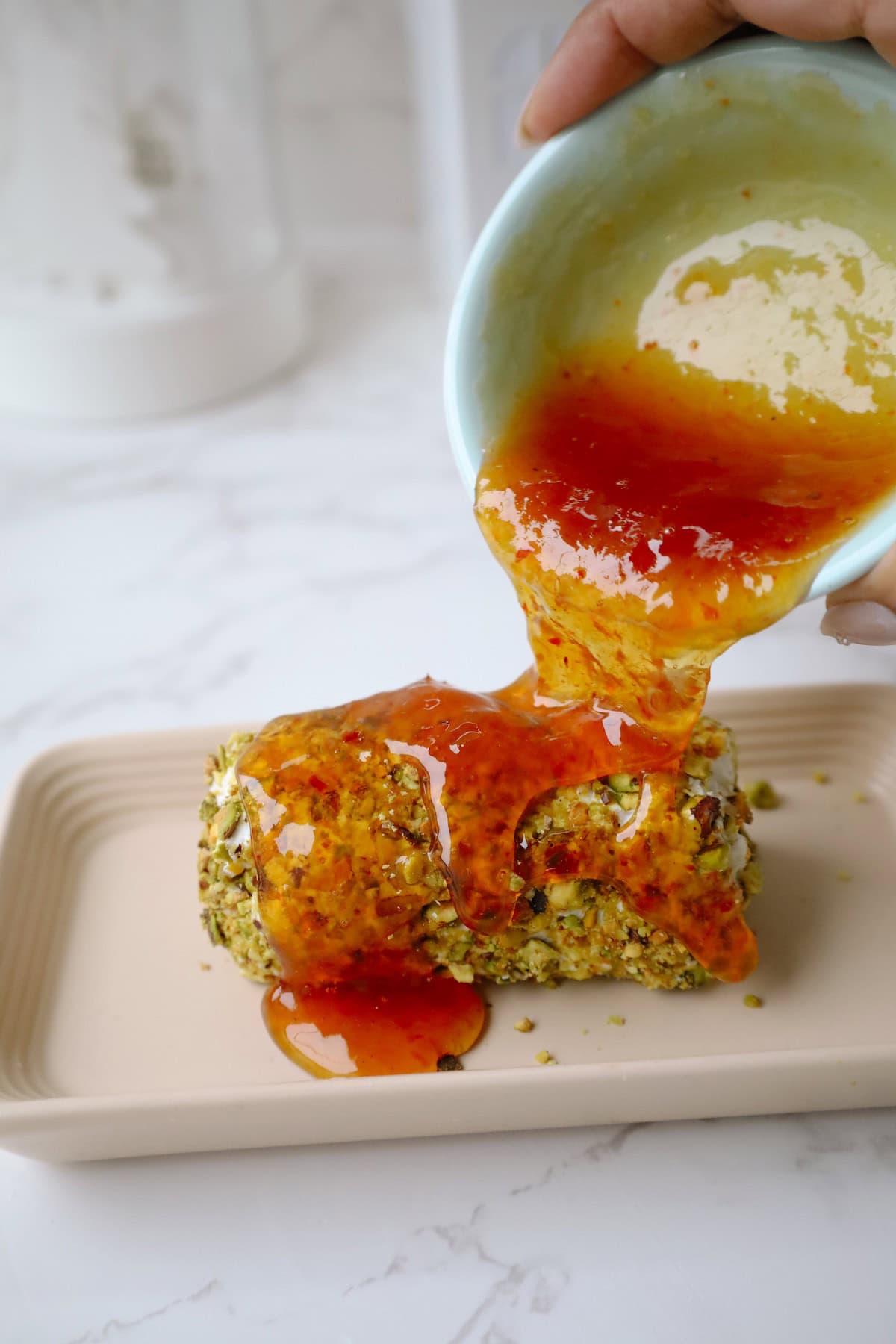 Step four: pour the jam onto the goat cheese appetizer.