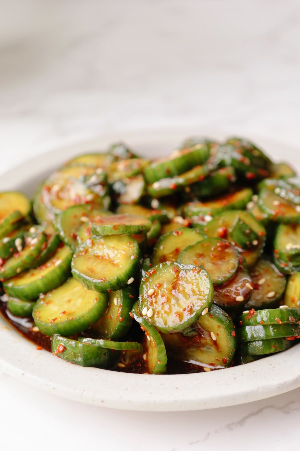 Korean cucumber salad on a white plate.