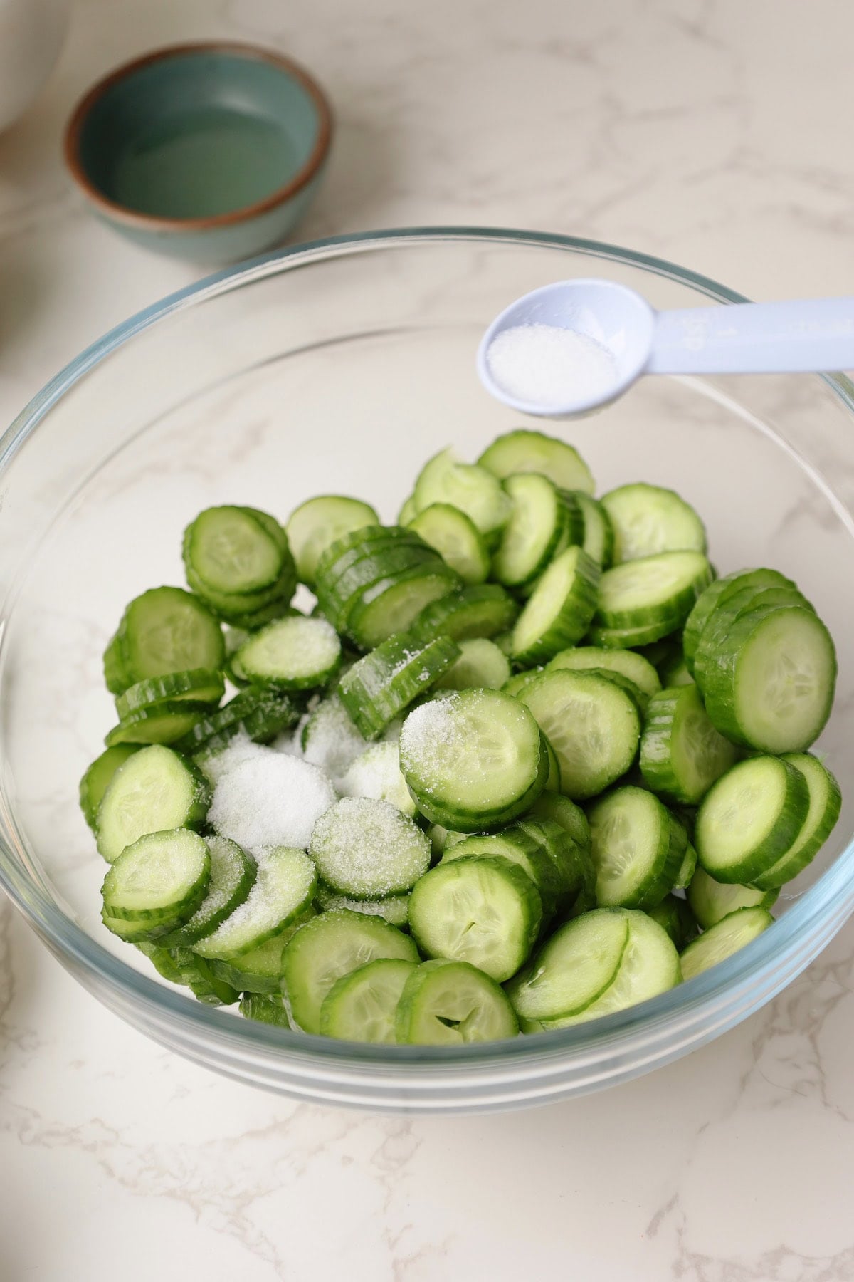 Salt the cucumbers for the Korean cucumber salad.