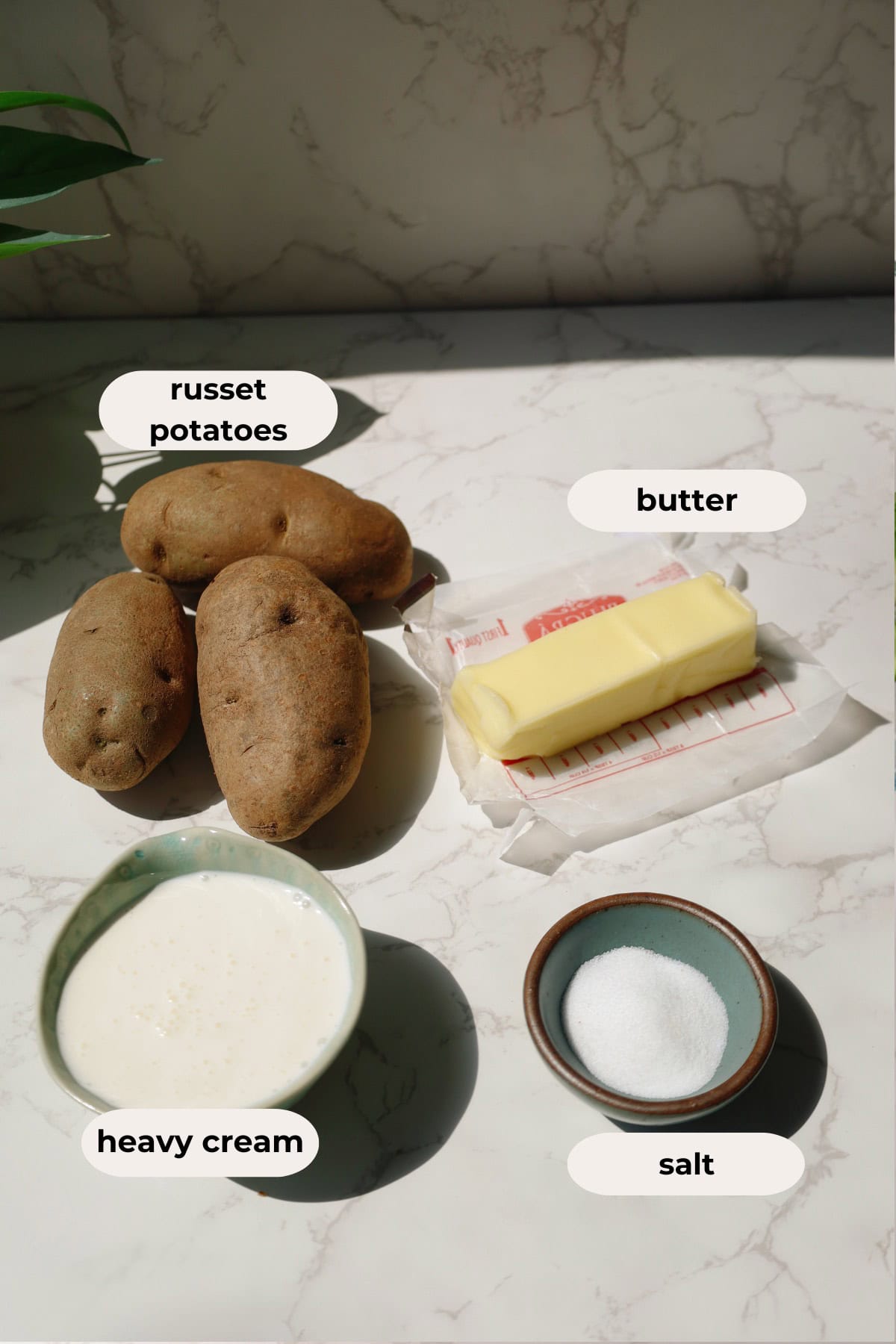Ingredients for the recipe: russet potatoes, butter, heavy cream, and salt.