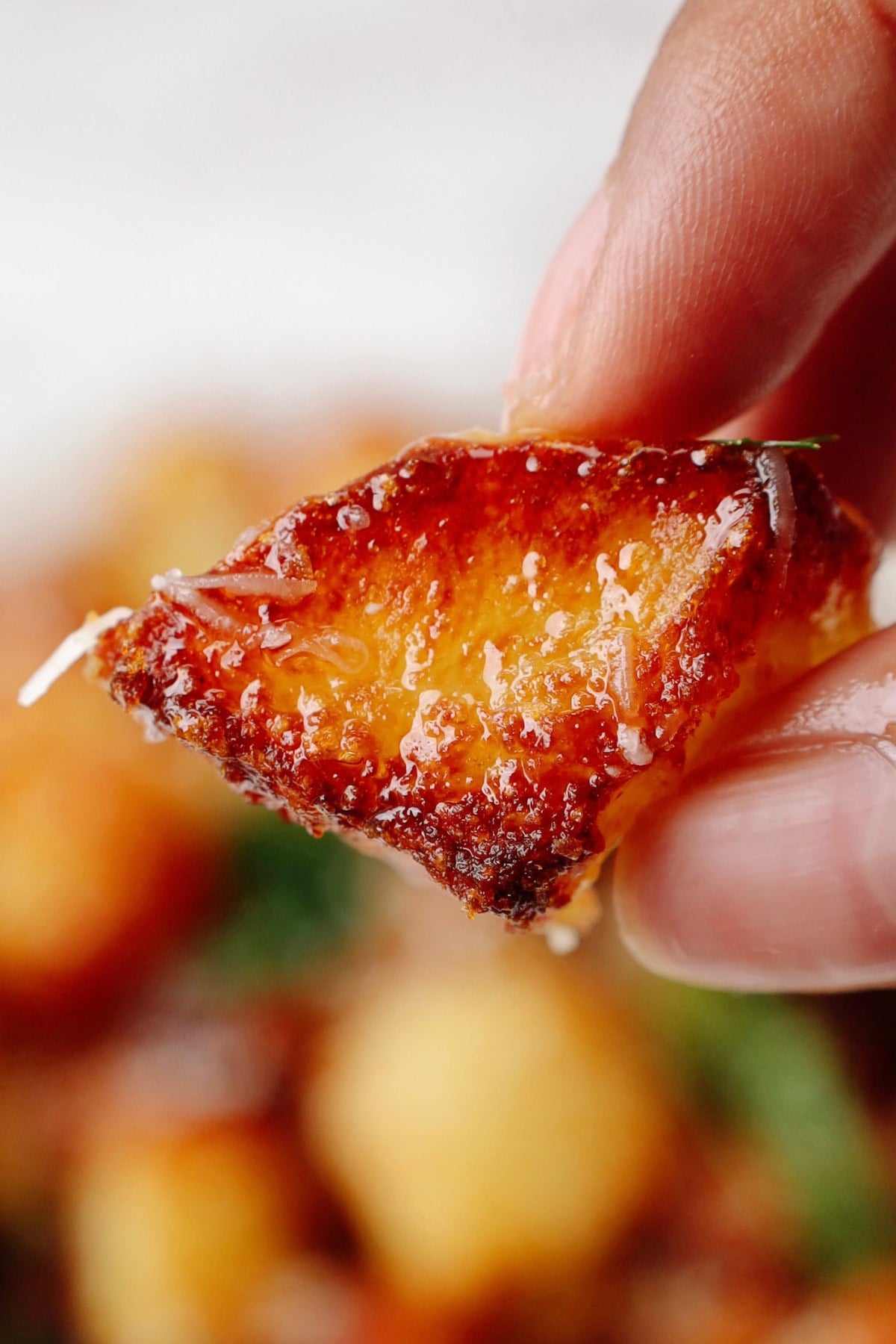 A crispy air fried potato held in someone's hand.