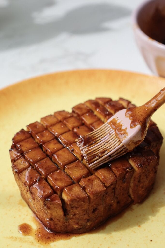 Brush the tofu with glaze.