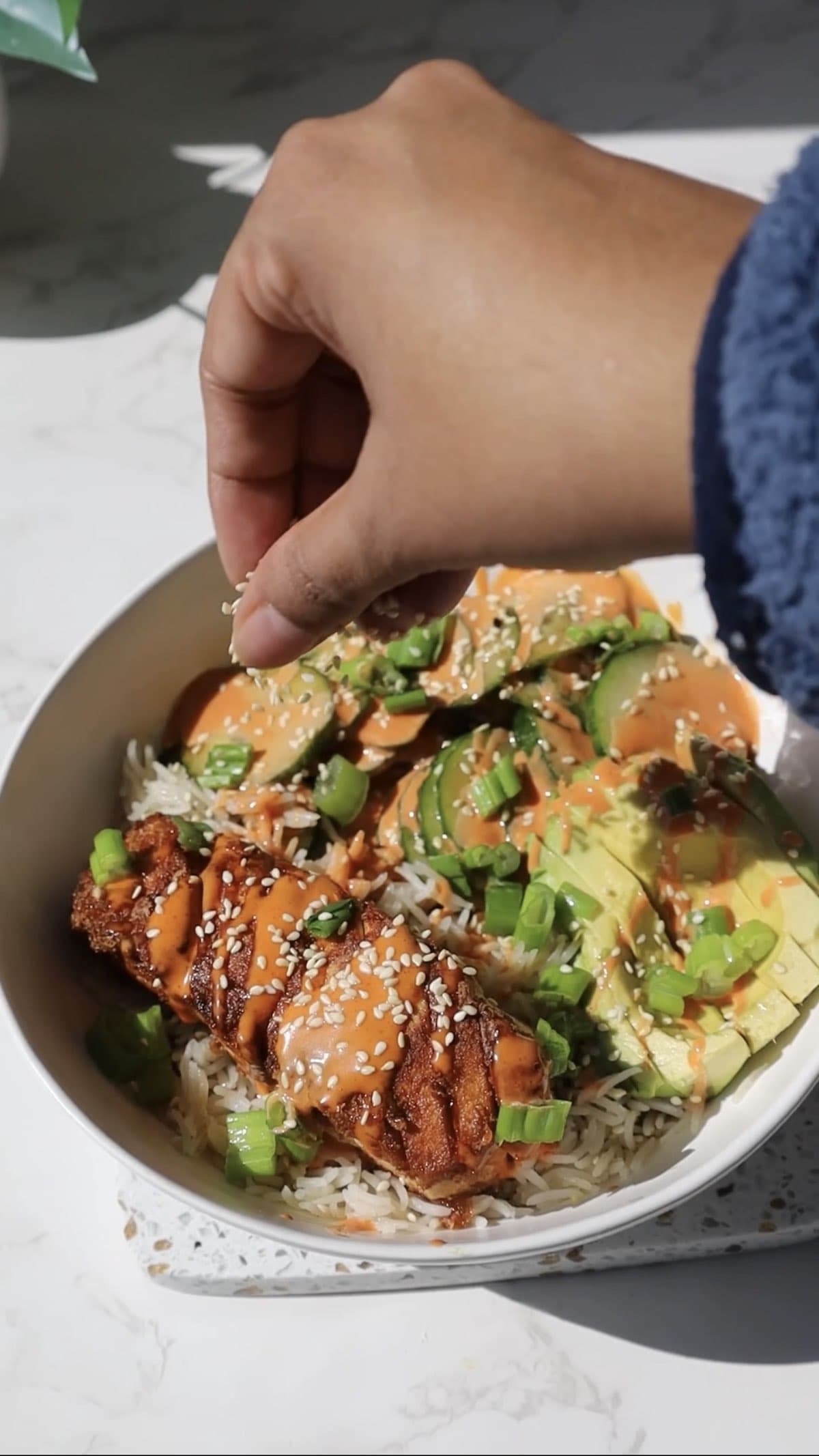 Tofu salmon bowl with avocado and cucumber.