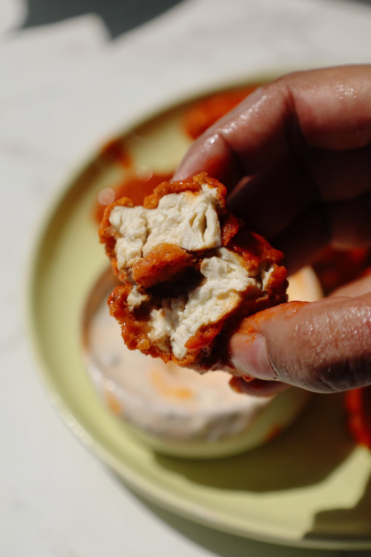 Vegan chicken nuggets broken in half to show the center.