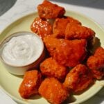 Vegan chicken nuggets with buffalo sauce and ranch.