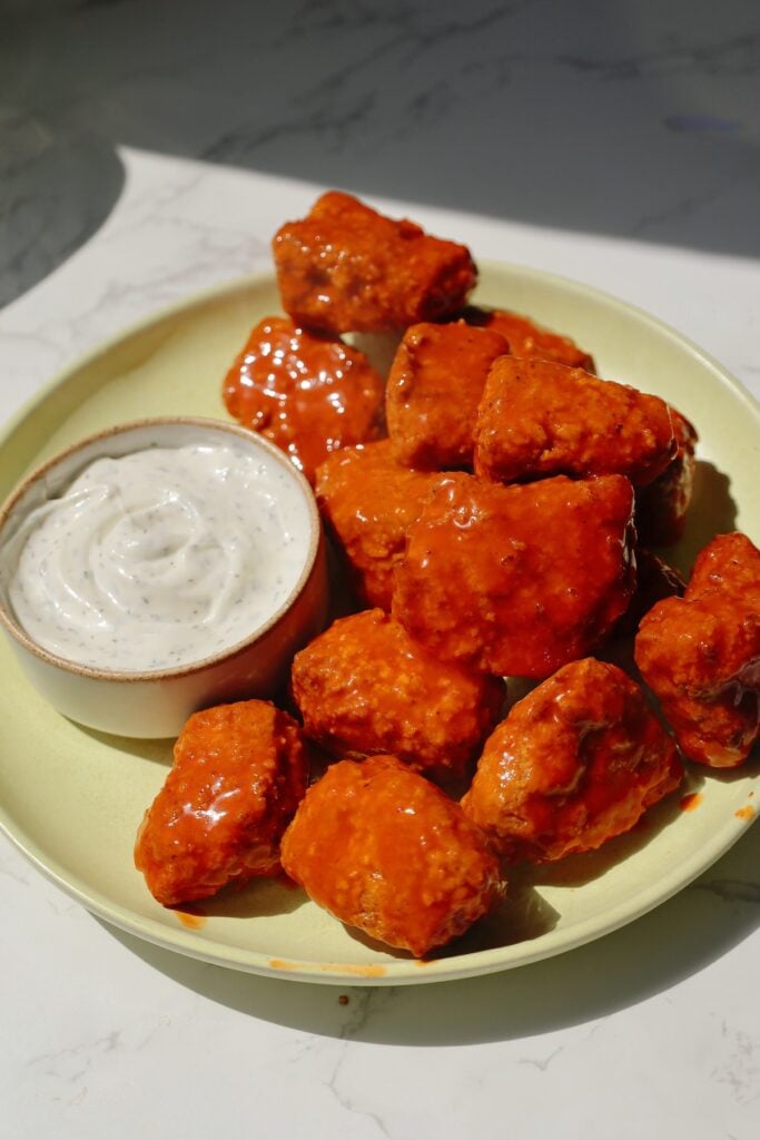 Vegan chicken nuggets with buffalo sauce and ranch.