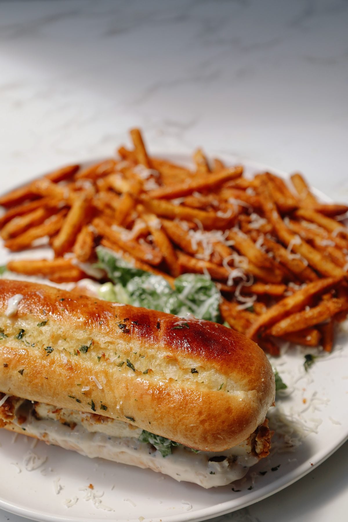 Vegetarian Caesar salad sandwich with garlic butter on top.