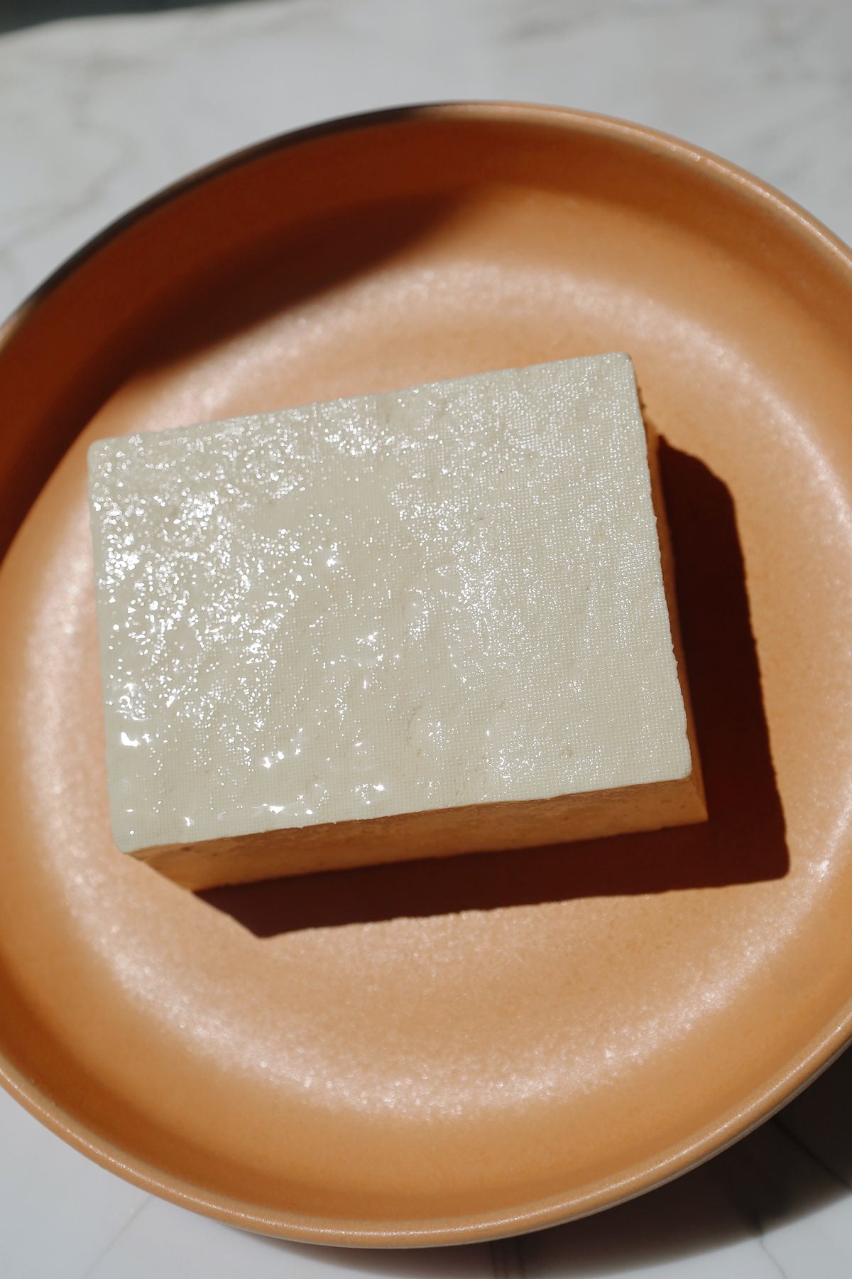 Extra firm tofu on a plate.