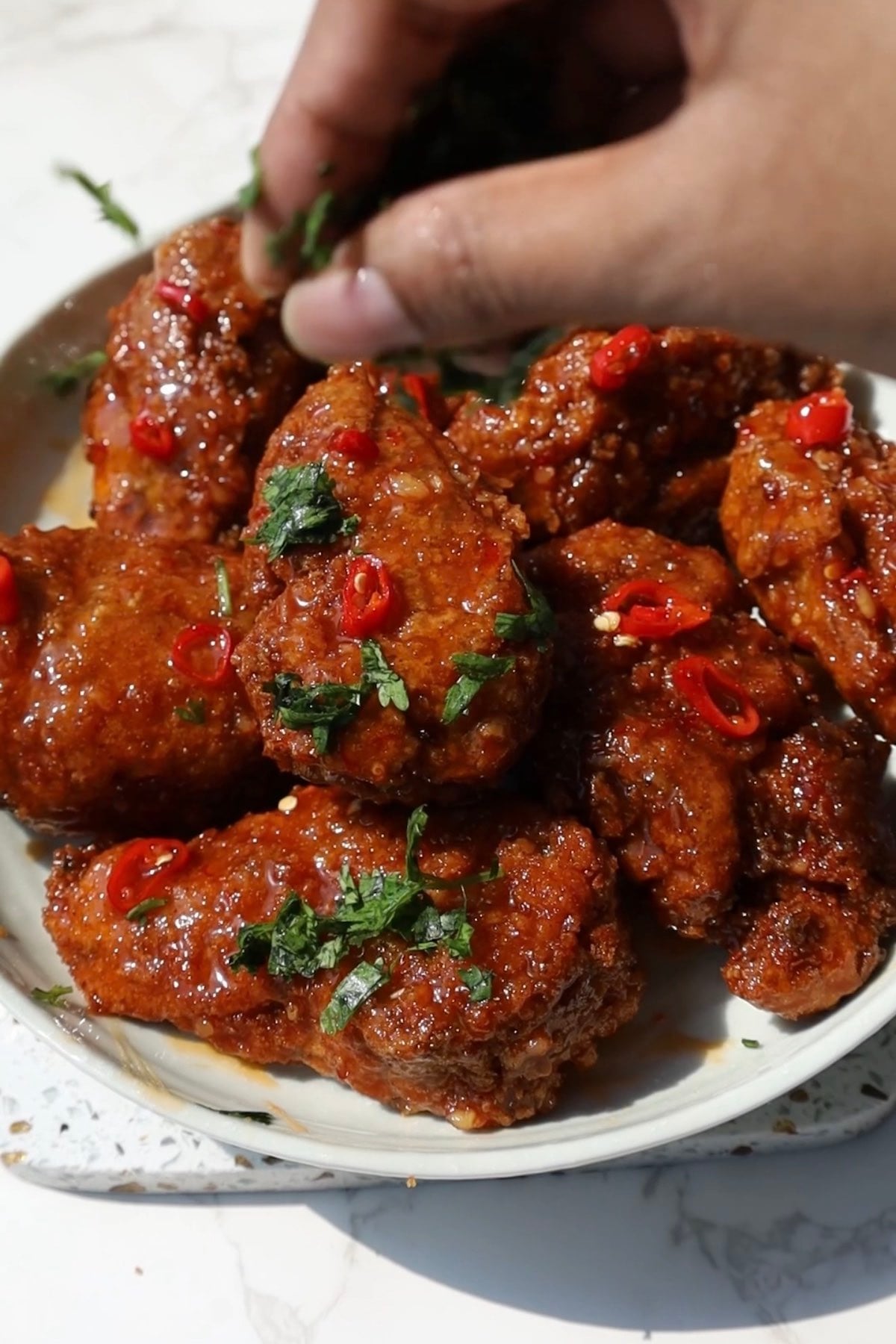 Thai sweet chili wings with parsley on top.