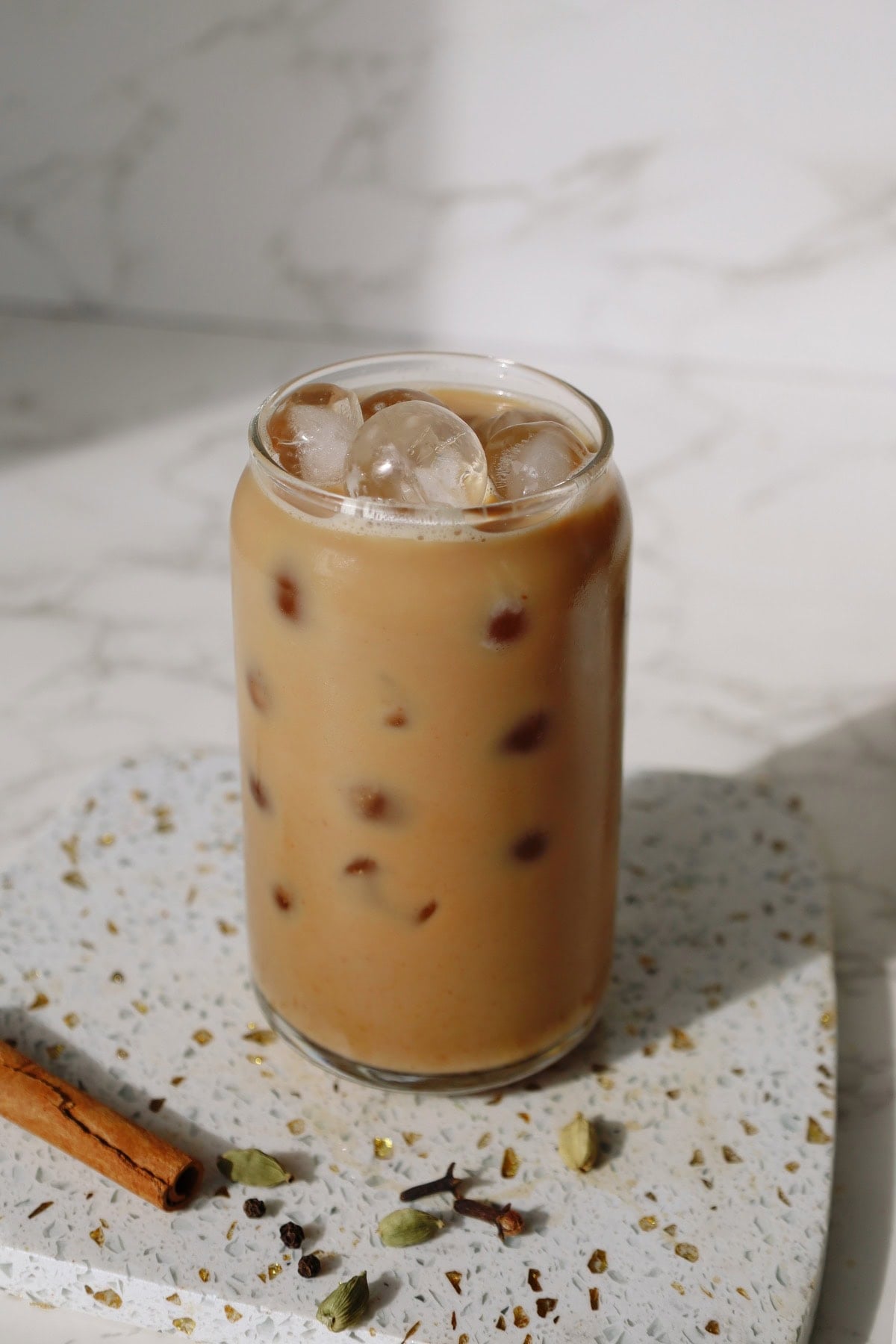 Iced chai latte in a tall glass.