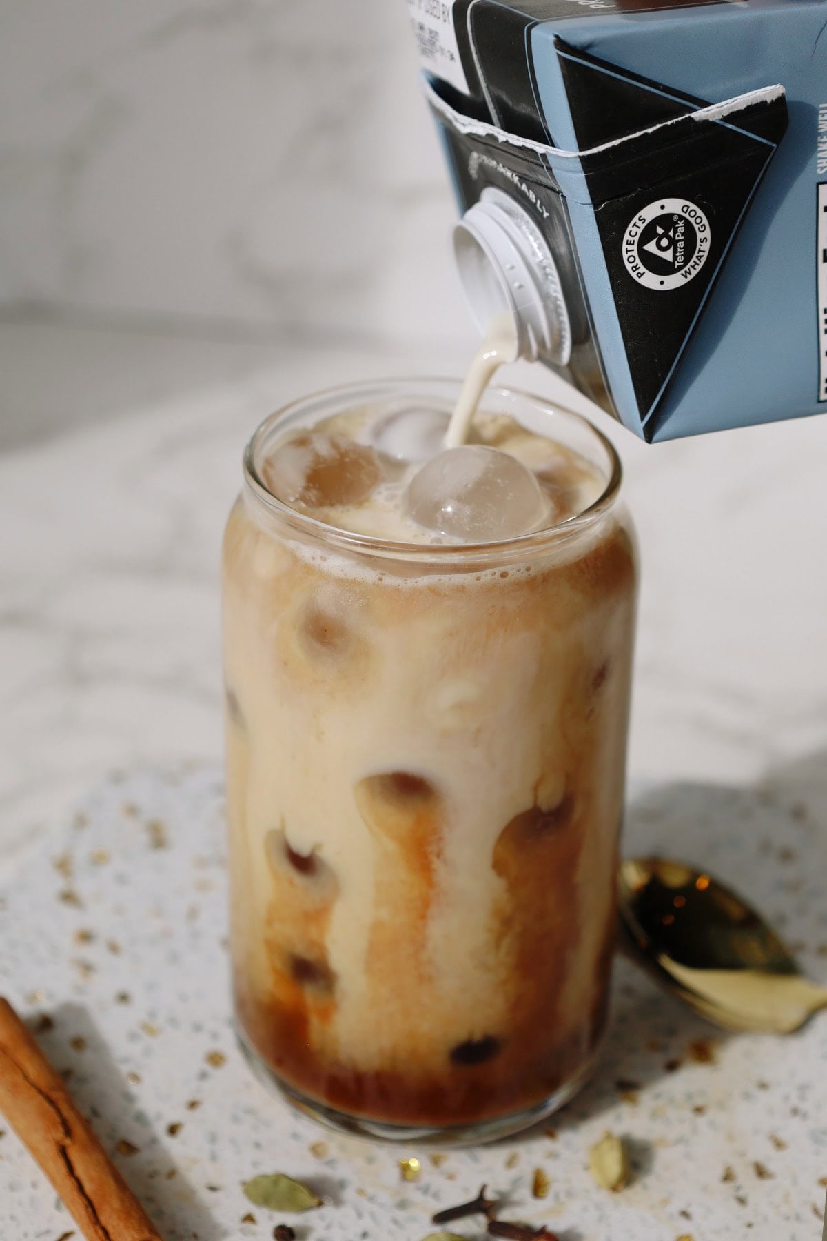 Pouring milk into the iced chai.