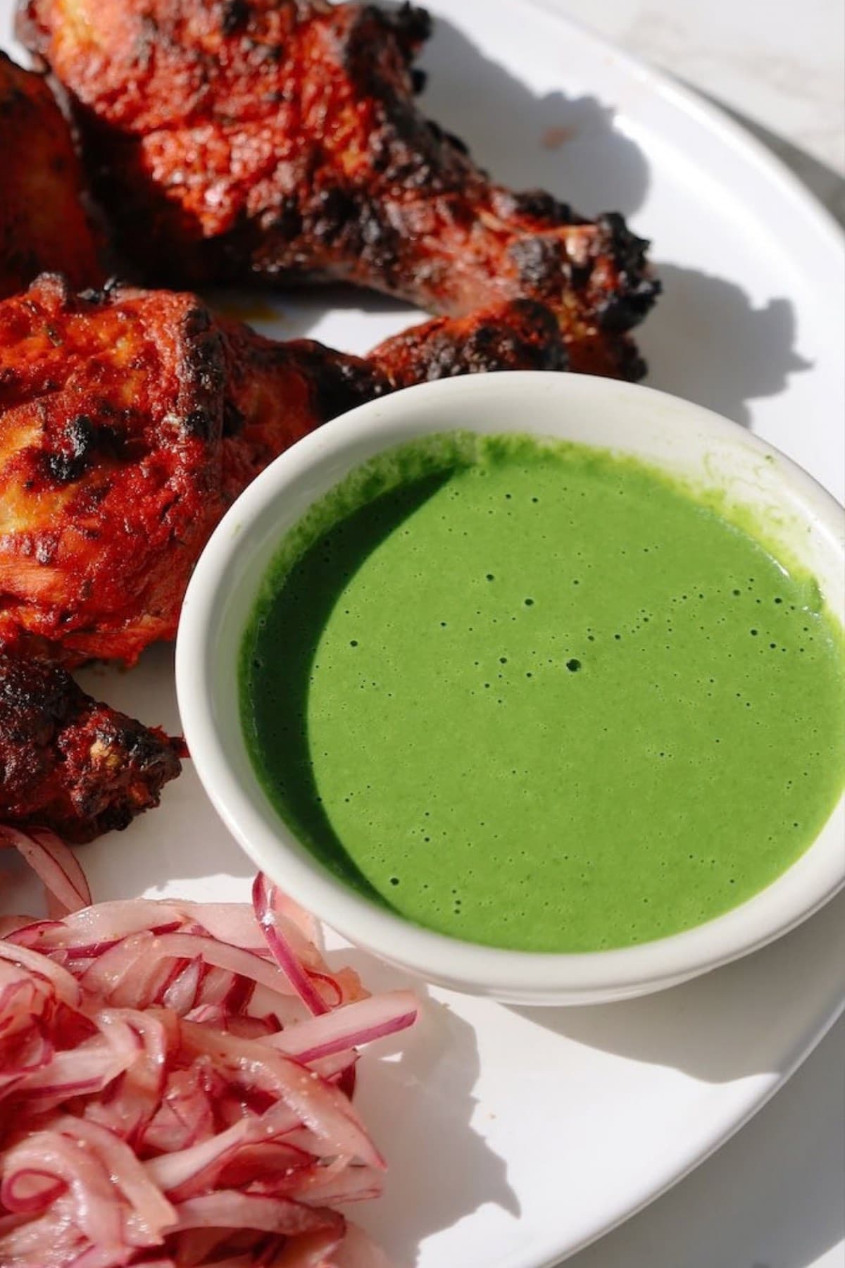 Sauce served with smoky tandoori chicken and pickled red onions.