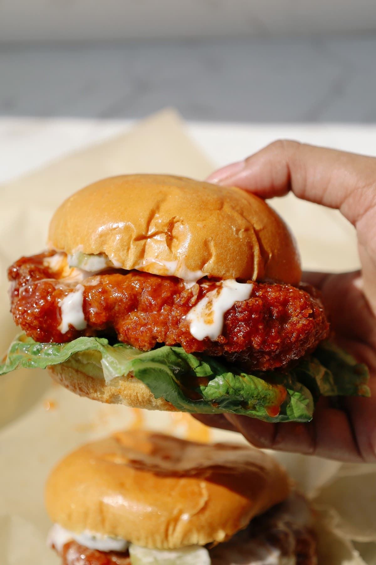 Oyster mushroom burger held in someone's hand.
