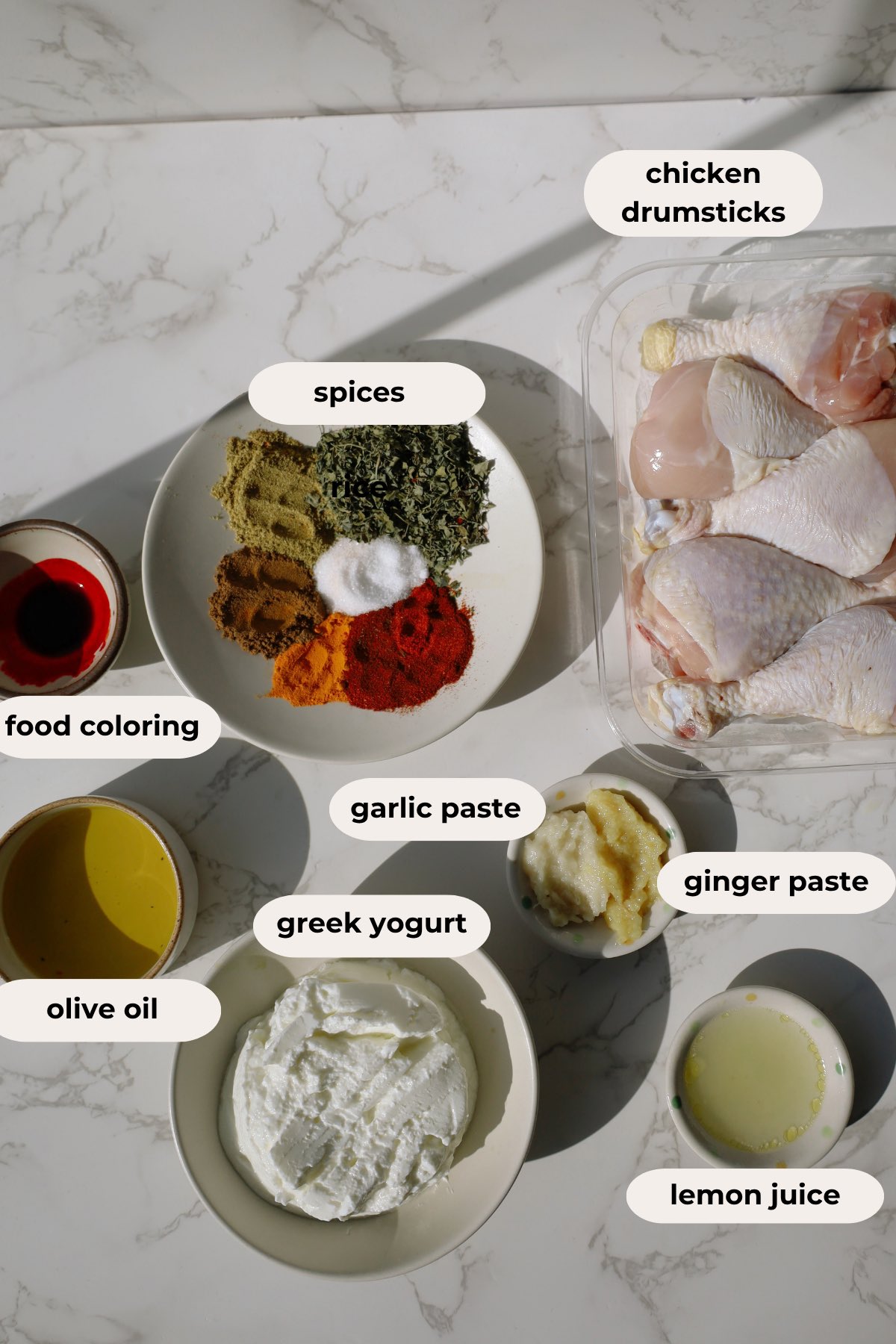 Tandoori chicken ingredients including drumsticks, Greek yogurt, Kashmiri chili powder, and spices.